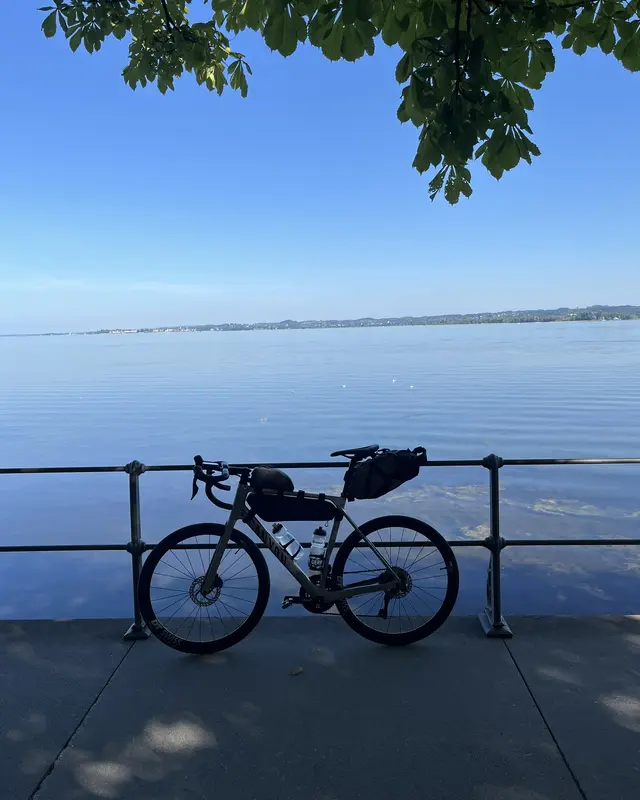 My road bike, packed for a long ride, against a railing by the lake